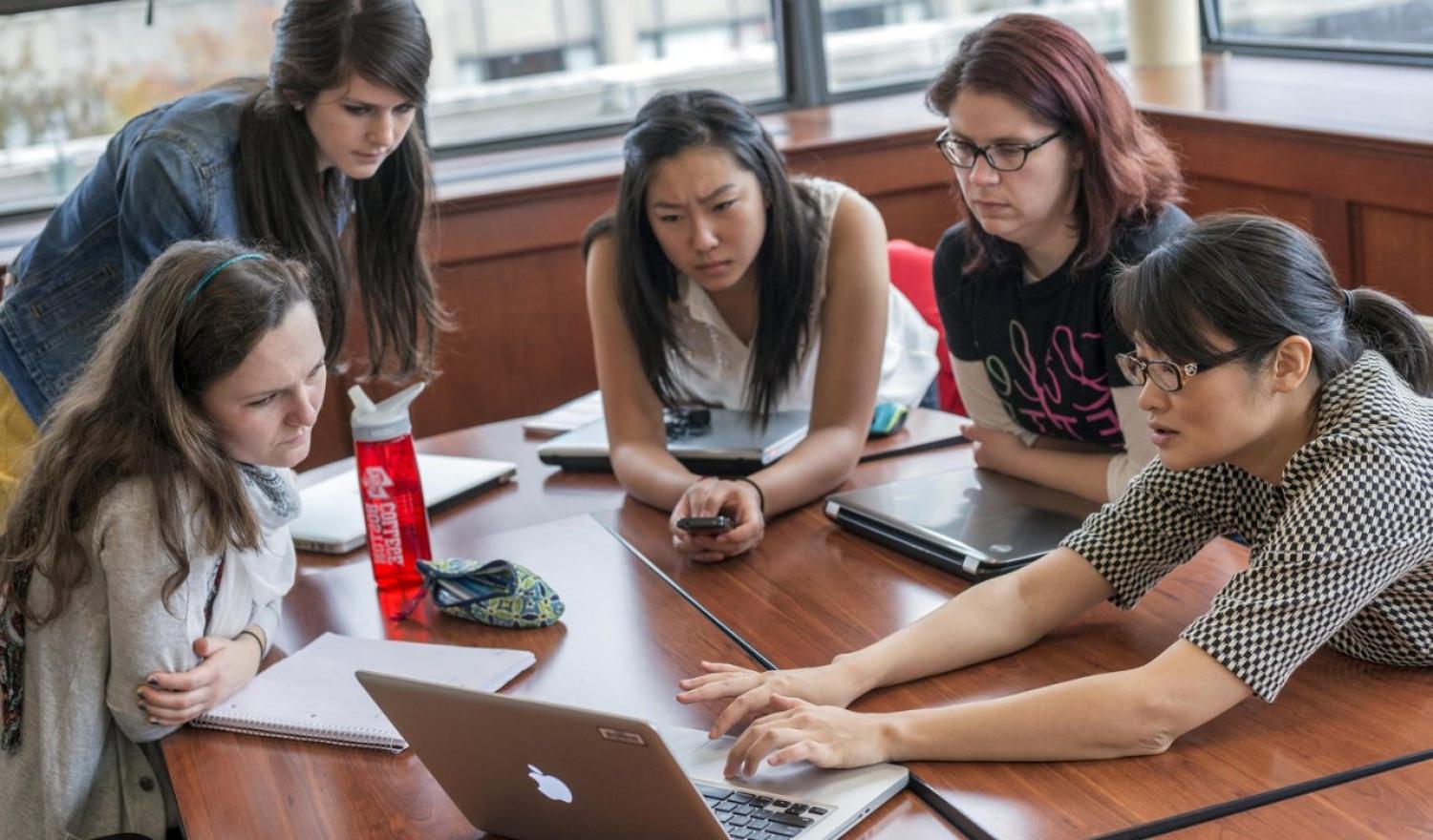 A group of ten students sitting in a circle having a conversation